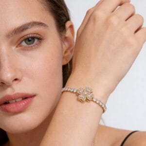 Sterling silver infinity heart bracelet with cubic zirconia crystals and white gold plating on a woman's wrist.