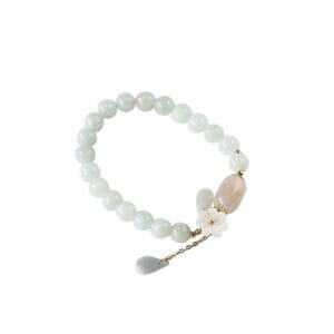 Handmade natural jadeite and apple agate beaded bracelet with a carved shell flower and 14K gold accents.