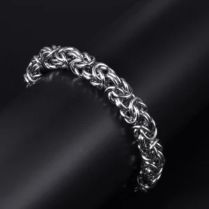 Hand-braided Byzantine chain bracelet made of silver-colored titanium steel on a male wrist.